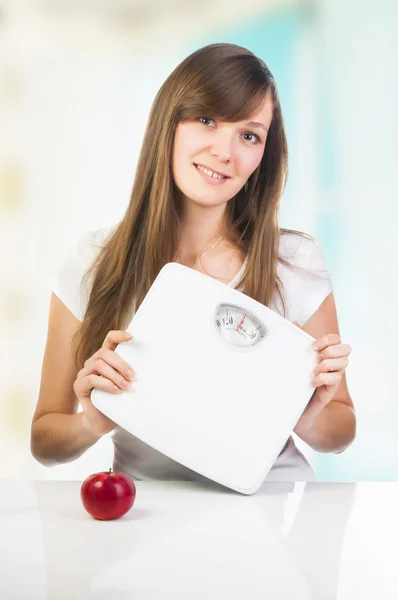 Young girl showing scales — Stock Photo, Image