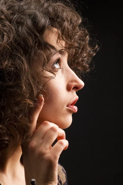 Portrait of young woman with curly hair Royalty Free Stock Images