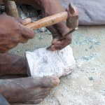 Man making white Buddha statues