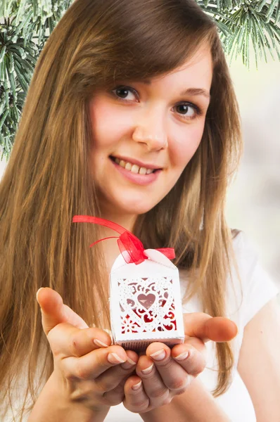 Woman holding small Christmas gift — Stock Photo, Image