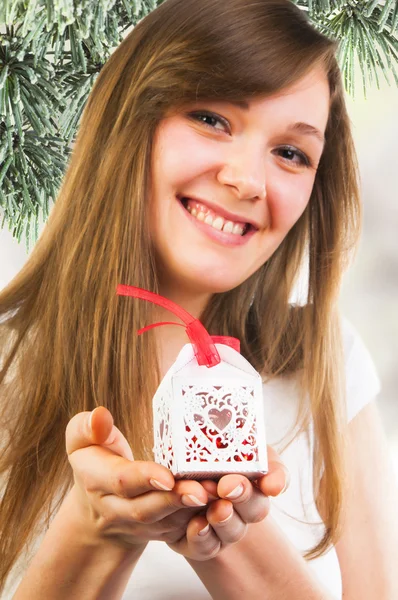 Woman holding small Christmas gift — Stock Photo, Image