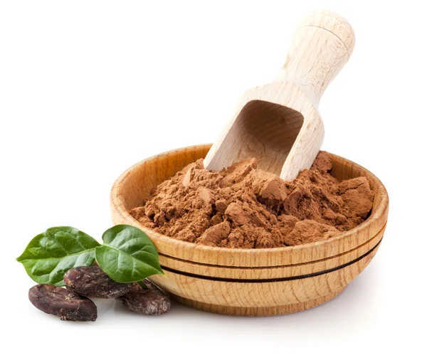 Cocoa powder and beans with green leaves — Stock Photo, Image