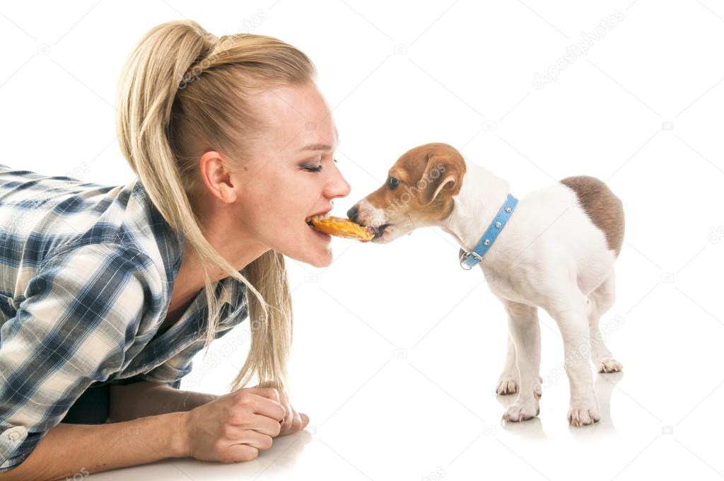 Woman eatting one biscuit with puppy