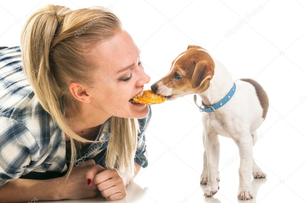 Woman eatting biscuit with puppy