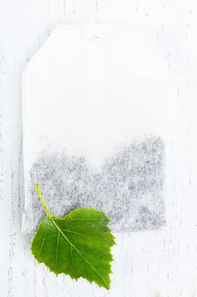 Birch leaf and tea bag — Stock Photo, Image