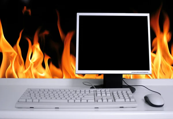PC with black desktop and fire flames background — Stock Photo, Image