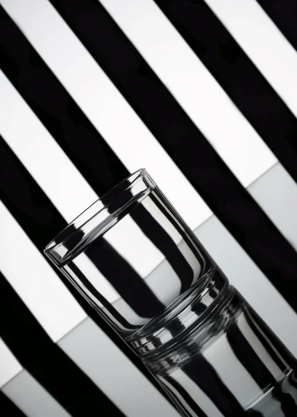 Glass of water with striped background — Stock Photo, Image