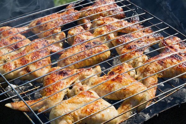 Grilling chicken on a barbecue Stock Picture