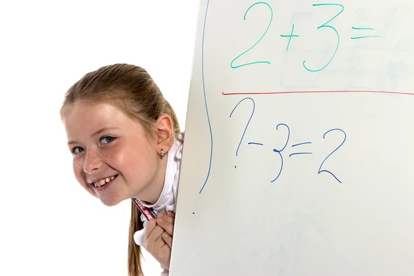 The cheerful schoolgirl looks from a board — Stock Photo, Image