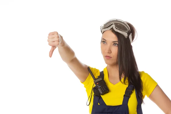 A female construction worker holding a down signal - isolated. — Stock Photo, Image