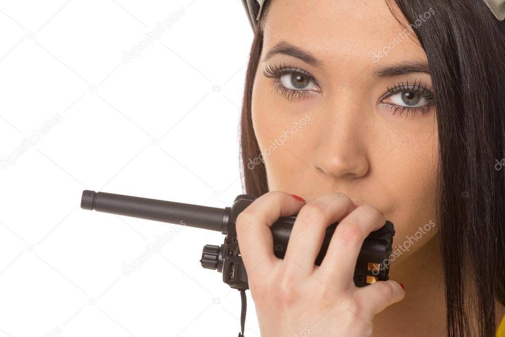 serious female construction worker talking with a walkie talkie