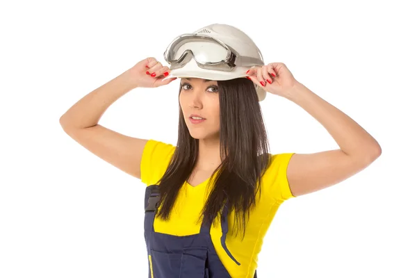 Serious female construction worker in helmet with goggles — Stock Photo, Image