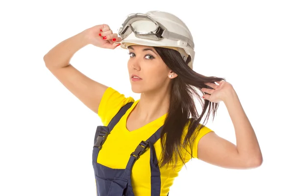 Serious female construction worker in helmet with goggles — Stock Photo, Image