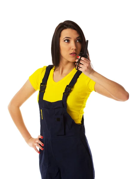 Female construction worker talking with a walkie talkie — Stock Photo, Image