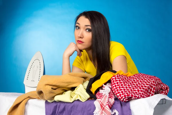 Houseworks, woman with pile of clothes for ironing — Stock Photo, Image