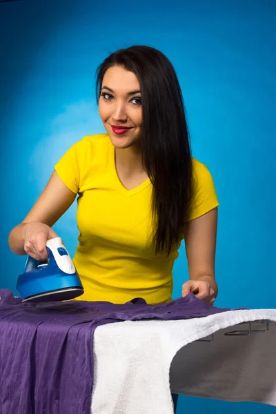 Houseworks, woman with pile of clothes for ironing — Stock Photo, Image