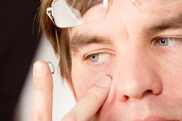 Closeup view of a man's brown eye while inserting a corrective c — Stock Photo, Image