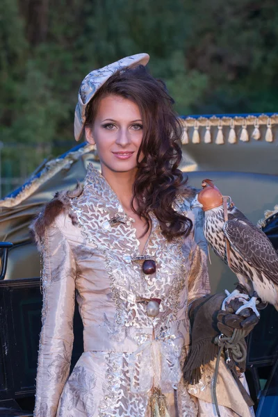 Woman with hawk on hand — Stock Photo, Image