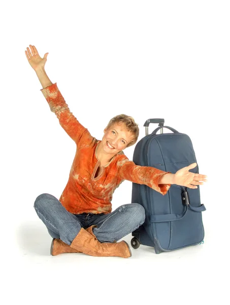 Woman sitting with suitcase on white — Stock Photo, Image
