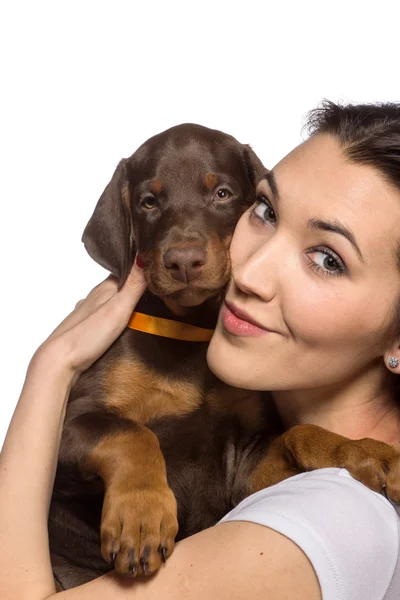 Brunette girl with her puppy isolated on white background — Stock Photo, Image