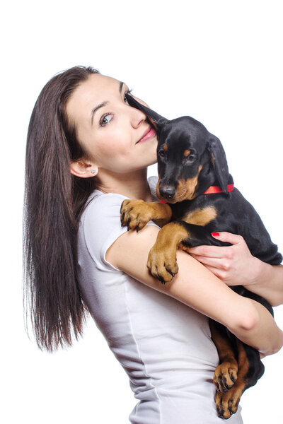 Brunette girl with her puppy isolated on white background