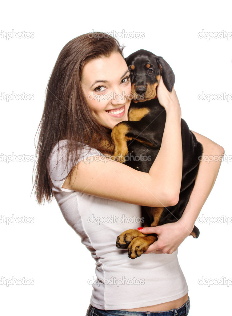 Brunette girl with her puppy isolated on white background