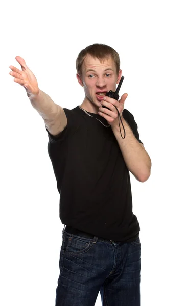 Young security officer talking through his walkie talkie. — Stock Photo, Image