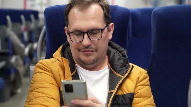 Tired man rides in suburban train — Stock Video