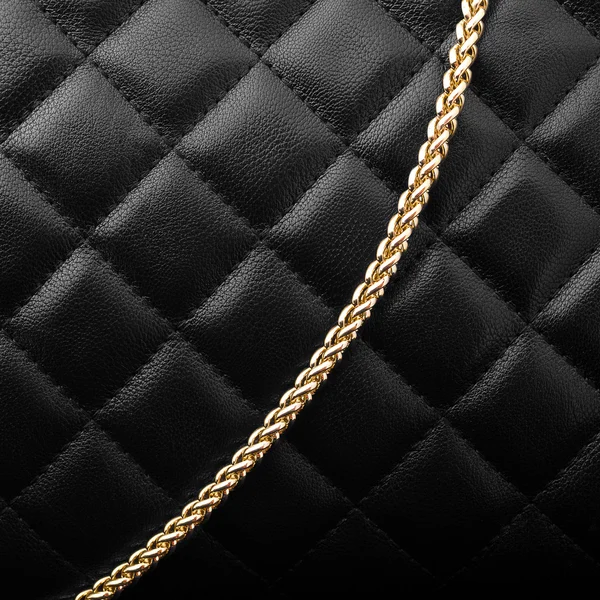 Black leather with golden chain — Stock Photo, Image