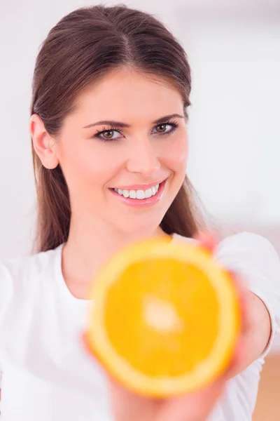 Beautiful girl with juicy orange — Stock Photo, Image