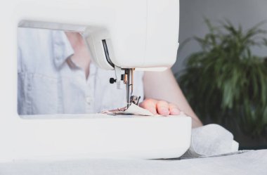 Evinde çalışırken dikiş diken bir kadın. Dikiş işlemi - Dikiş arkasında kadın elleri