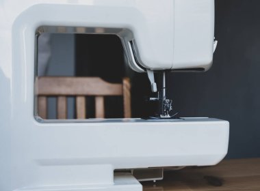 Dikiş atölyesindeki bir masada dikiş makinesi.