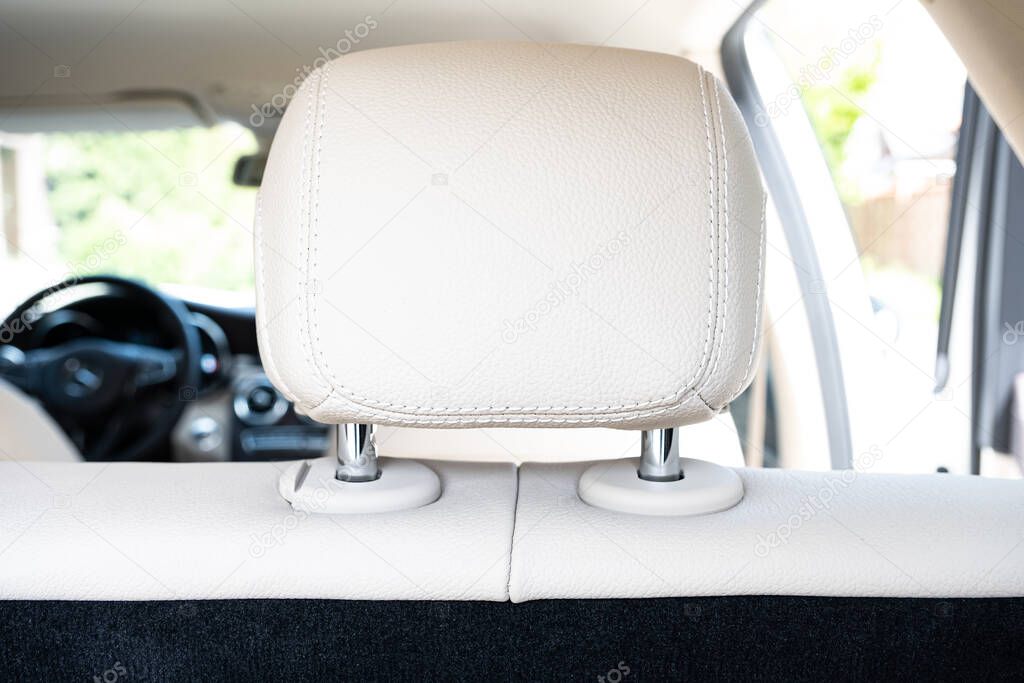 Headrest in modern luxury comfortable car with the beige perforated leather