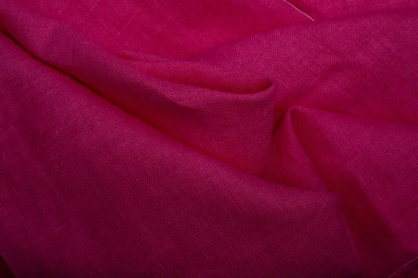 Pink linen Canvas fabric background. Magenta colored cloth background. Fuchsia color fabric. Pink pure linen texture