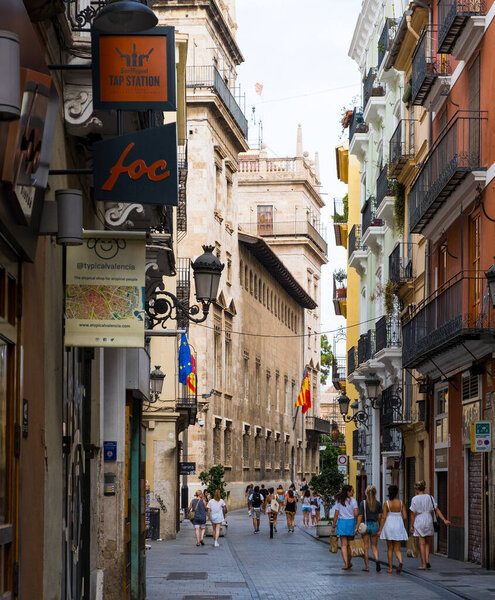 Valencia, Spain - August 06, 2019: Tourists on the streets of Valencia on a hot summer day. Travel, shopping and leisure