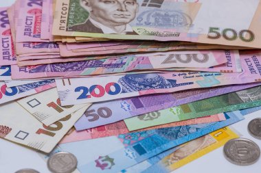 Ukrainian hryvnia, background. The concept of receiving wages, pensions, inflation, deposit and credit. The concept of increasing prices for utilities, energy, gas. Crisis during the war in Ukraine