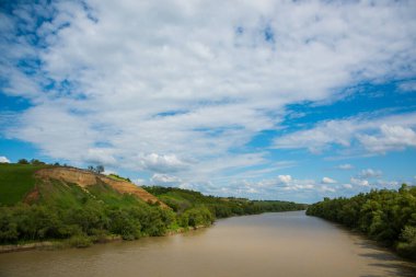 Summer rural landscape. River and high steep banks