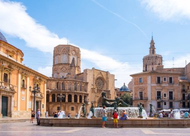 Valencia, Spain - August 07, 2019: View at the Fountain of Turia, Cathedral and Basilica of Our Lady at the Virgin Square of Valencia