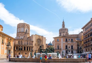 Valencia, Spain - August 07, 2019: View at the Fountain of Turia, Cathedral and Basilica of Our Lady at the Virgin Square of Valencia