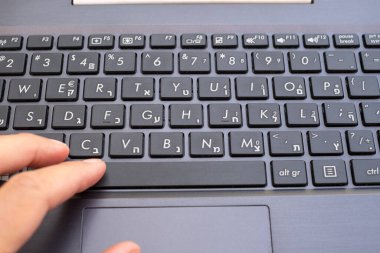 Hebrew keyboard. Top view of keys. Pressing button, concept of learning Hebrew language, working. Black keyboard close up, front view, selective focus