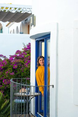 Caucasian smiling boy outdoors on the balcony looking at the camera