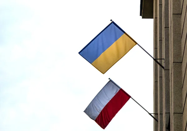 The flag of Poland and Ukraine together on the facade of building. Its a symbol of opposition to Russian aggression, a sign of solidarity and help Ukraine