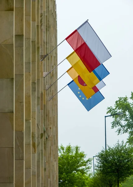 The flags of Poland, Ukraine, Lublin Voivodeship and European Union on the office business building background. Its a symbol of opposition to Russian aggression, a sign of solidarity and help Ukraine