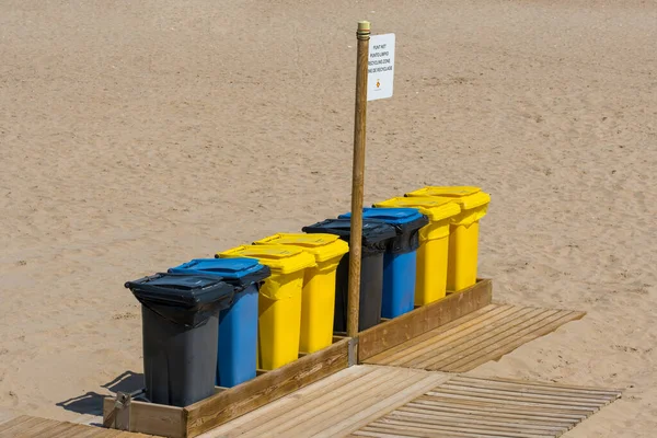 Separate waste collection food waste, biodegradable, non biodegradable and recycle trash bin. Multicolor trash bin on a sandy beach in Sitges, Spain