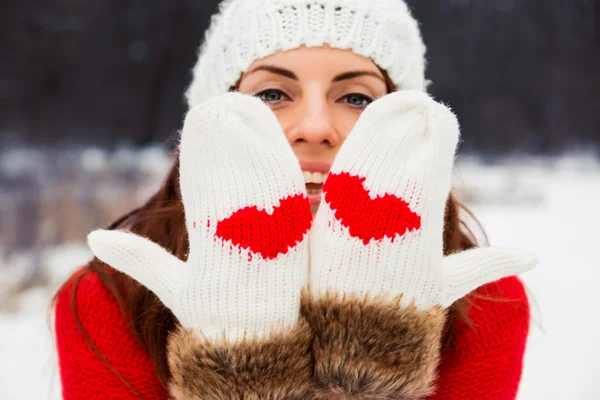 Pretty yong woman in mittens with hearts — Stock Photo, Image