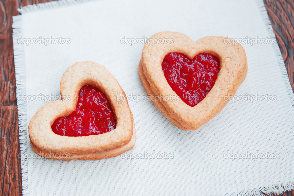 Two heart-shaped cookies with jam