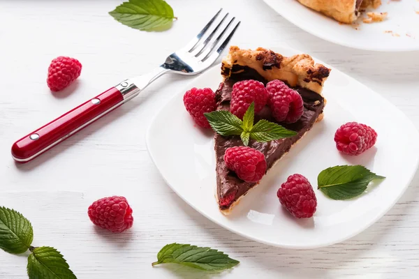 A piece of chocolate tart with raspberry — Stock Photo, Image