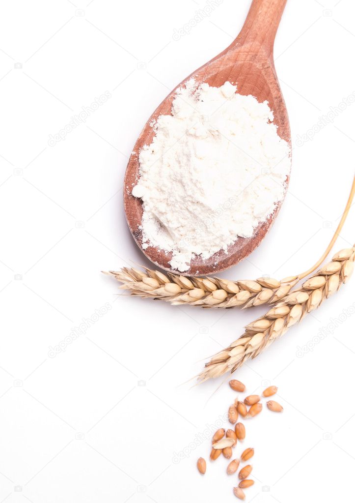Ears of wheat and flour on the white background