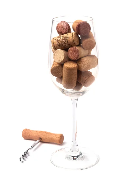 Copo de vinho cheio de rolhas de vinho — Fotografia de Stock