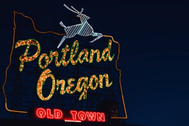 Iconic Portland, Oregon Old Town sign with an outline of Oregon and a stag at night